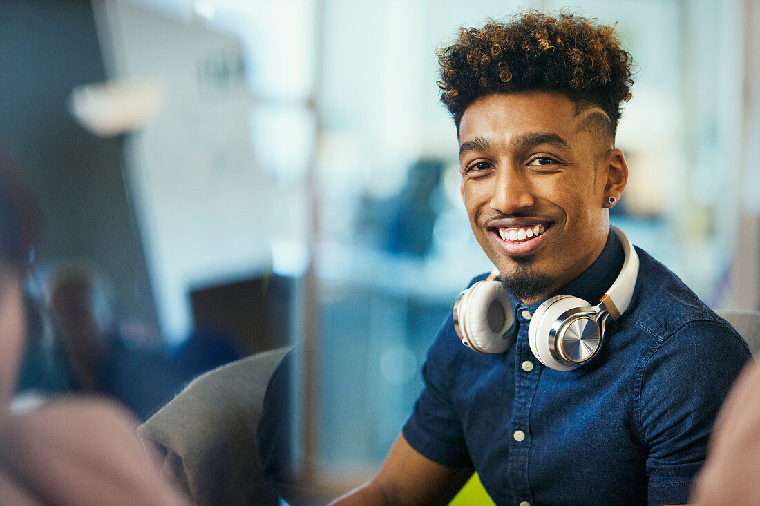 Portrait smiling creative businessman with headphones
