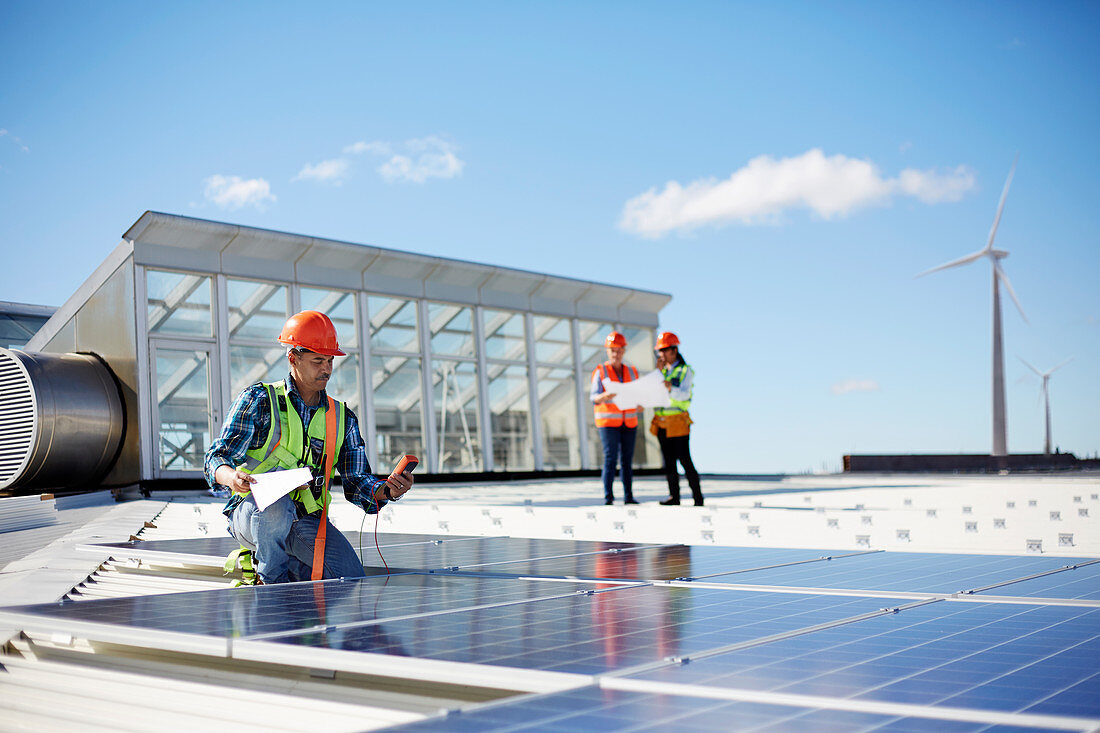 Engineer testing solar panels at sunny power plant