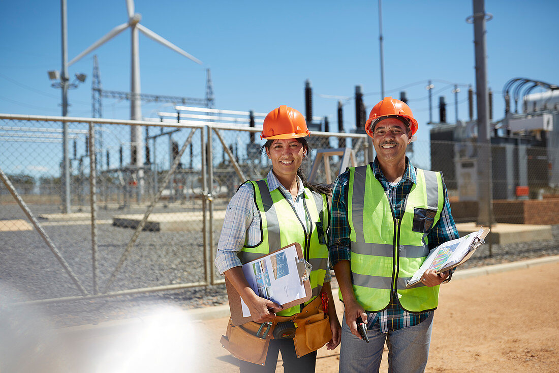 Portrait engineers with clipboards at power plant