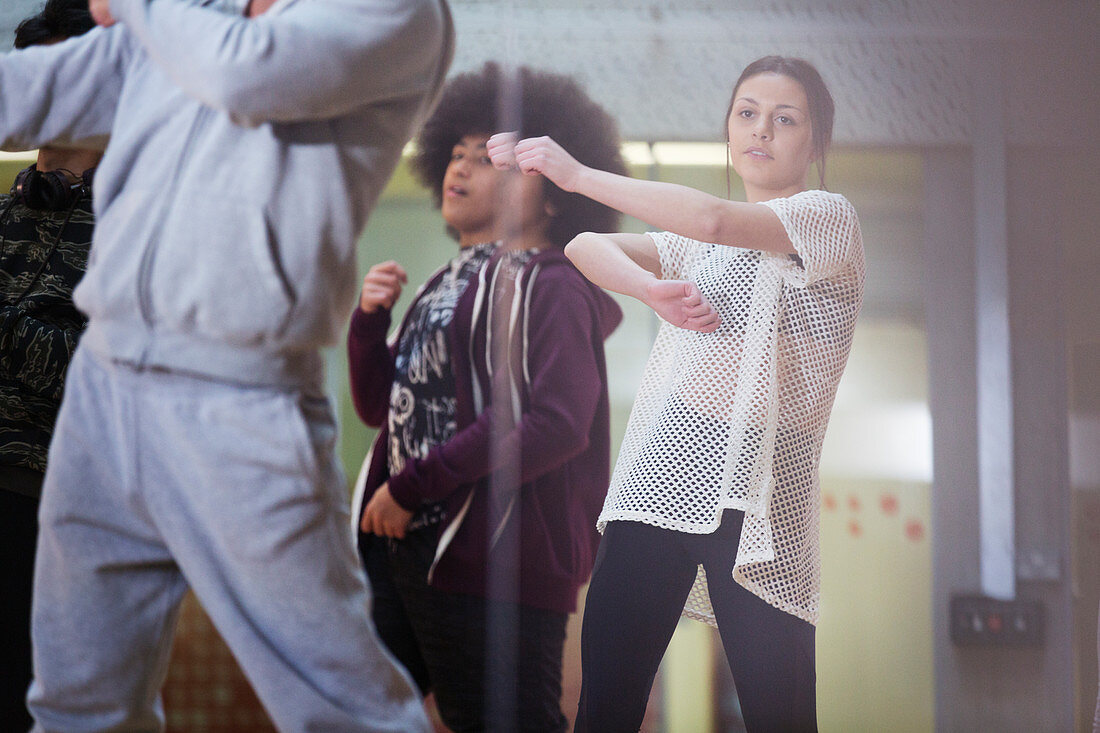 Focused teenage girl dancing in dance class studio