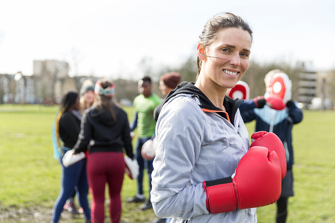 Portrait smiling woman boxing in park