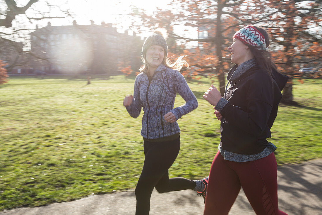 Smiling female runners running