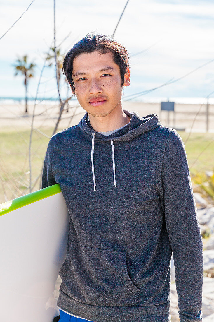Portrait male surfer with surfboard