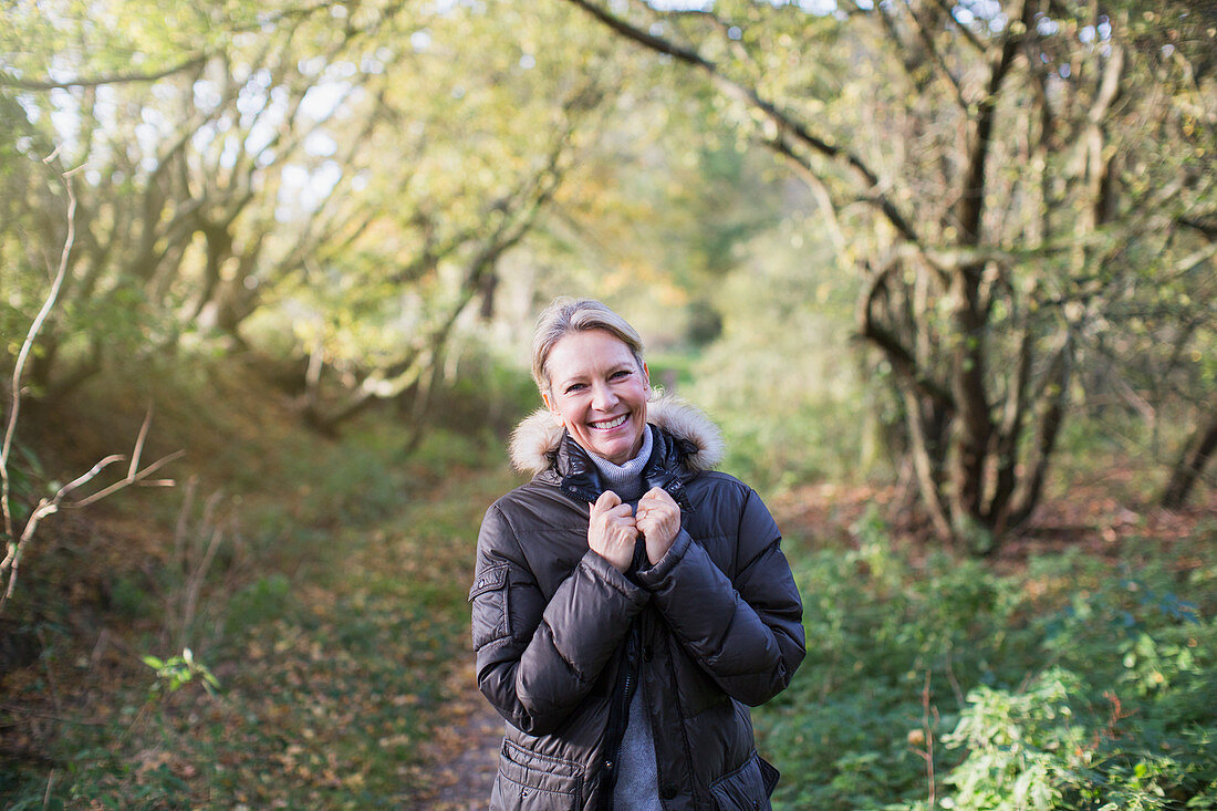 Mature woman in sunny autumn woods