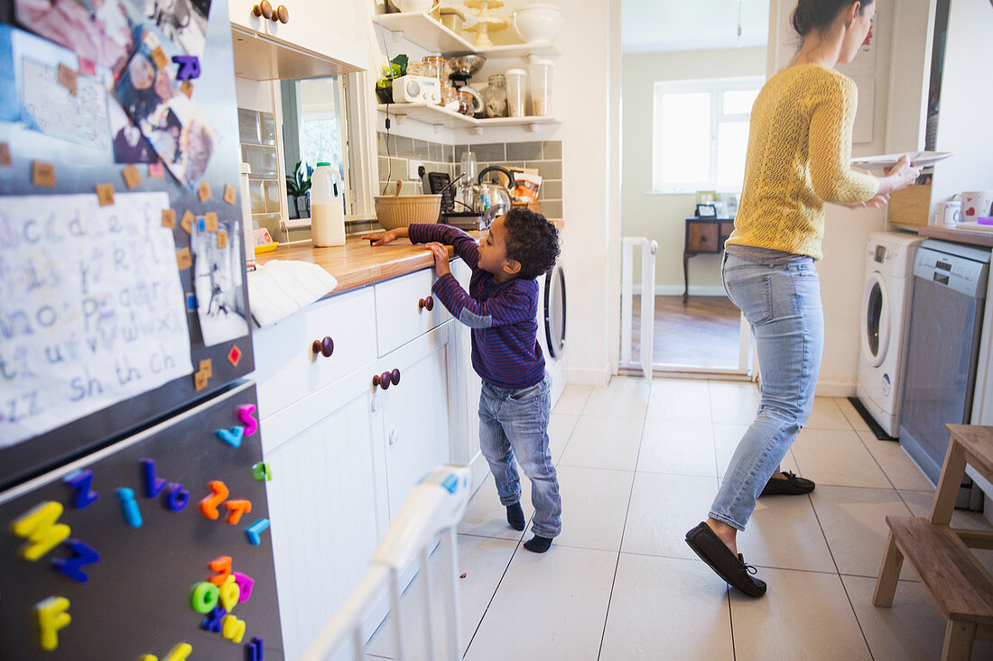 Mother and toddler son in kitchen