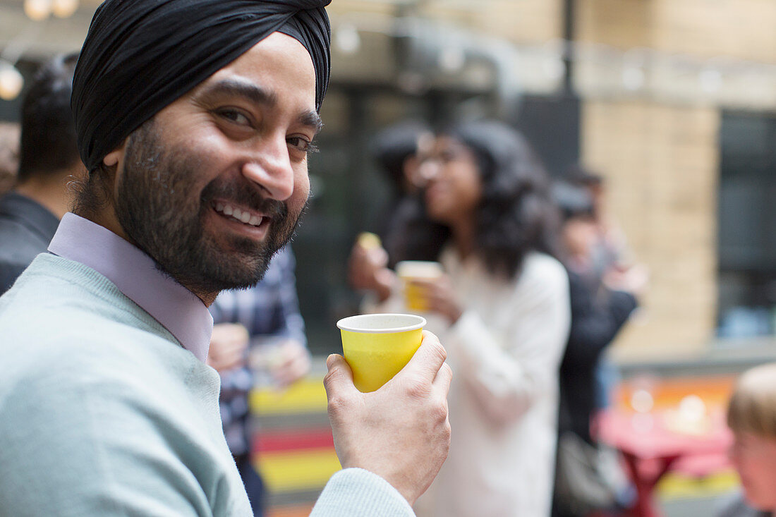 Portrait man in turban drinking, enjoying party