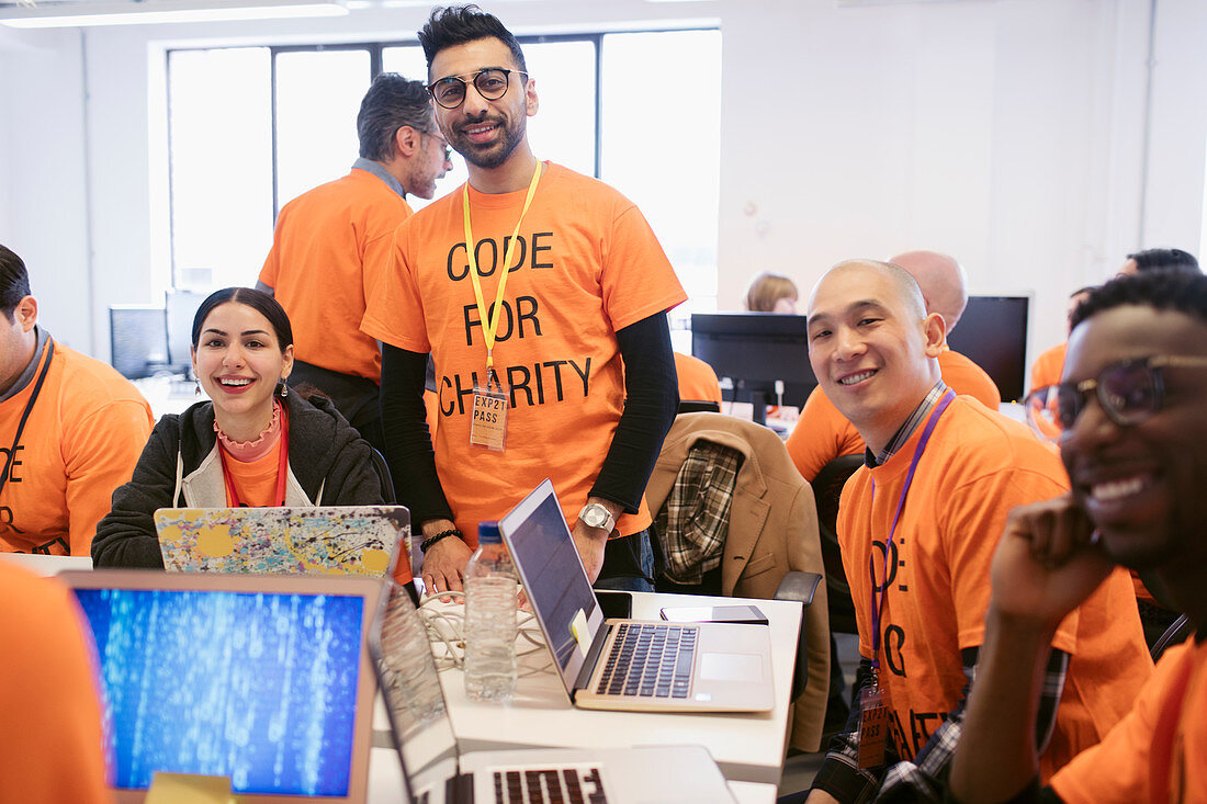 Portrait hackers coding for charity at hackathon