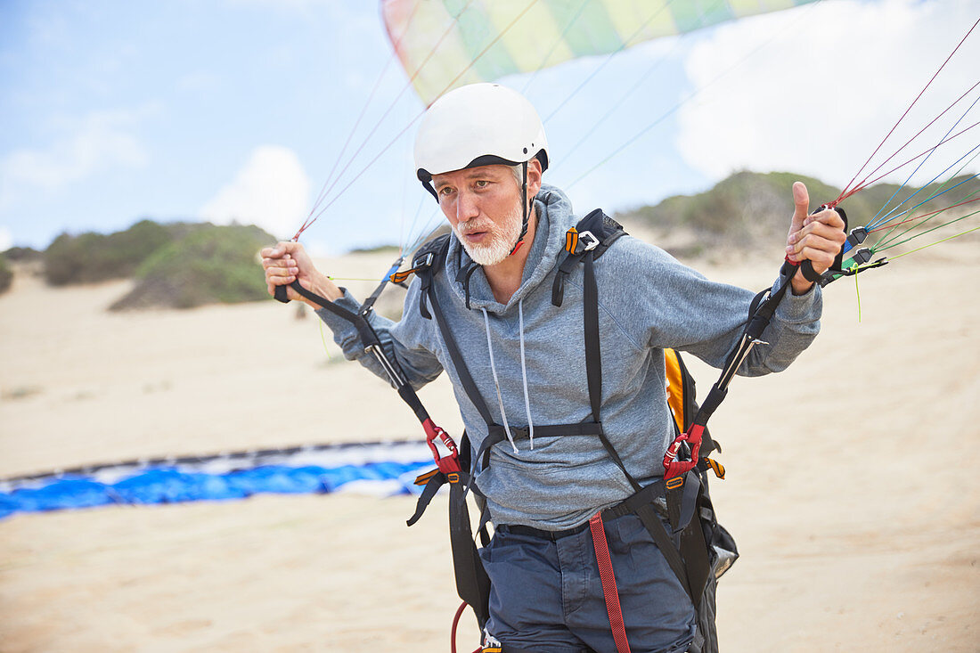 Focused mature male paraglider