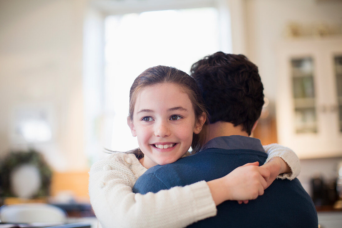 Happy daughter hugging father