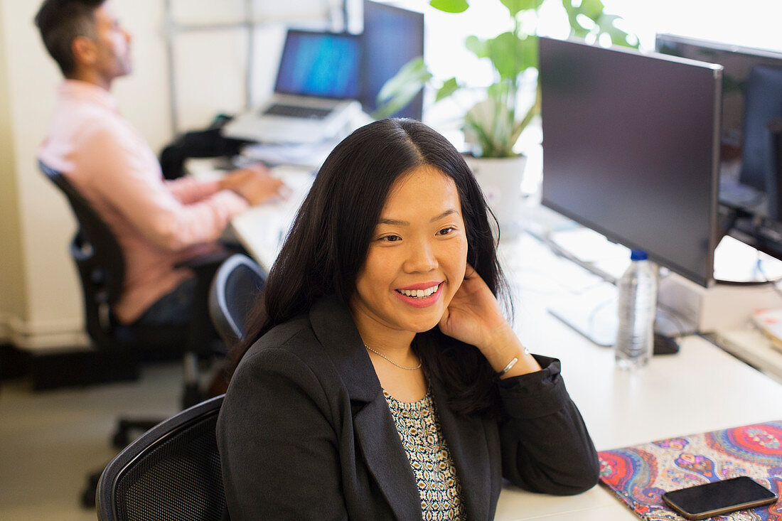 Smiling businesswoman working in office