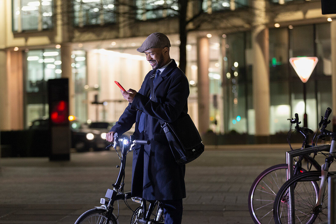 Businessman with bicycle at night