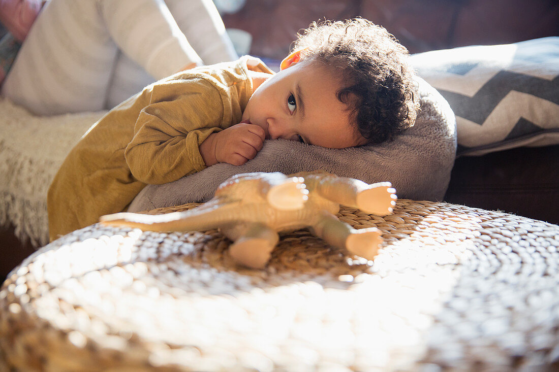 Tired baby boy sucking thumb