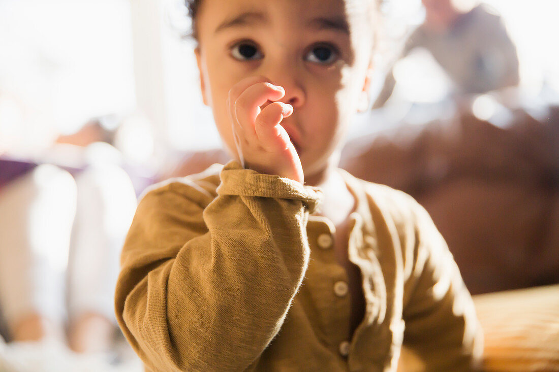 Close up innocent baby boy sucking thumb