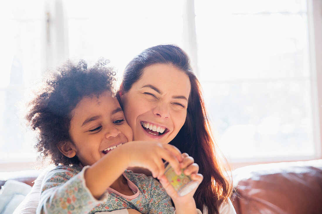 Laughing, carefree mother and daughter