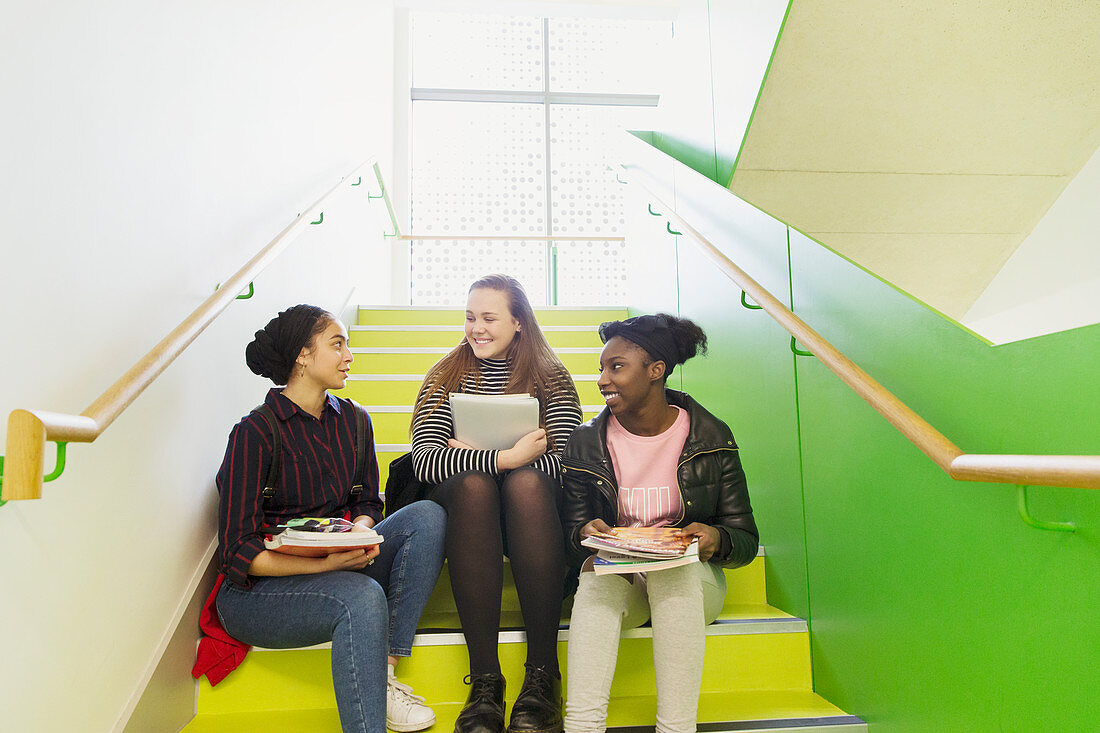 High school girls talking on stairs