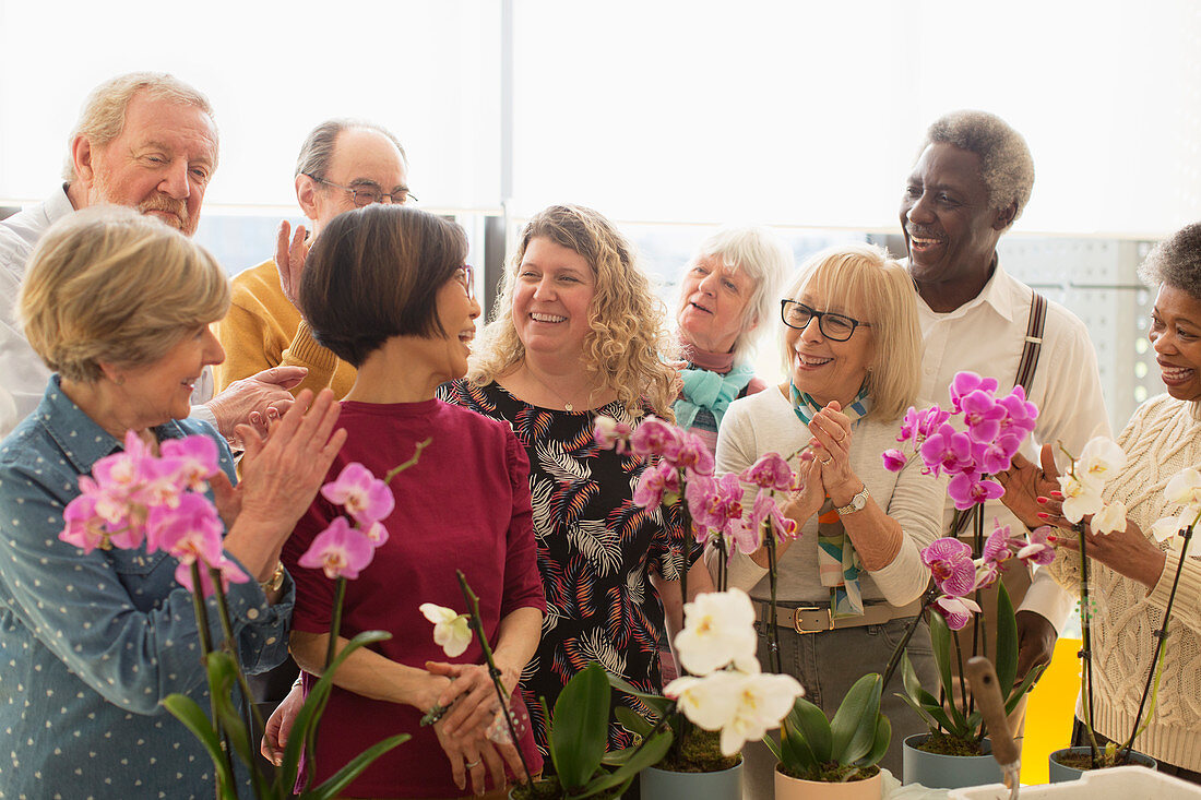 Happy seniors enjoying flower arranging class