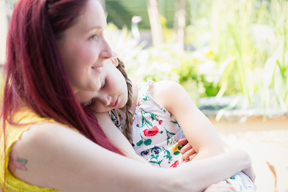 Affectionate mother holding daughter