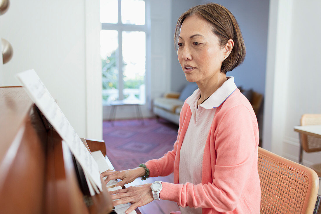 Active senior woman playing piano