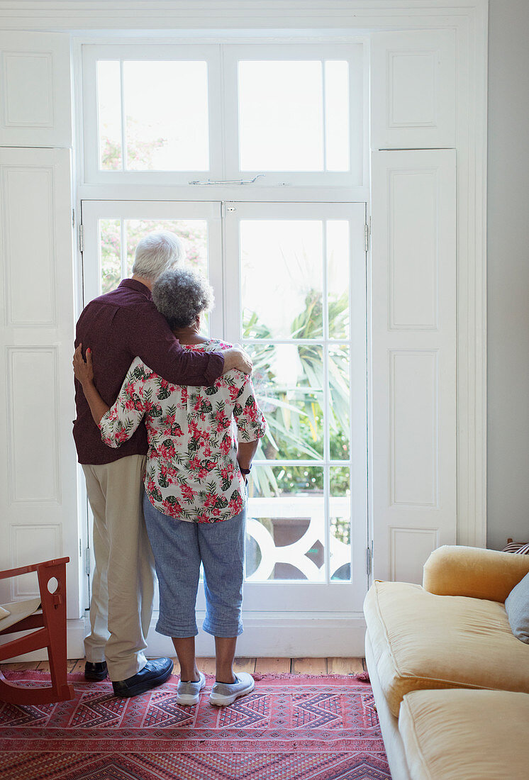 Serene senior couple looking out window