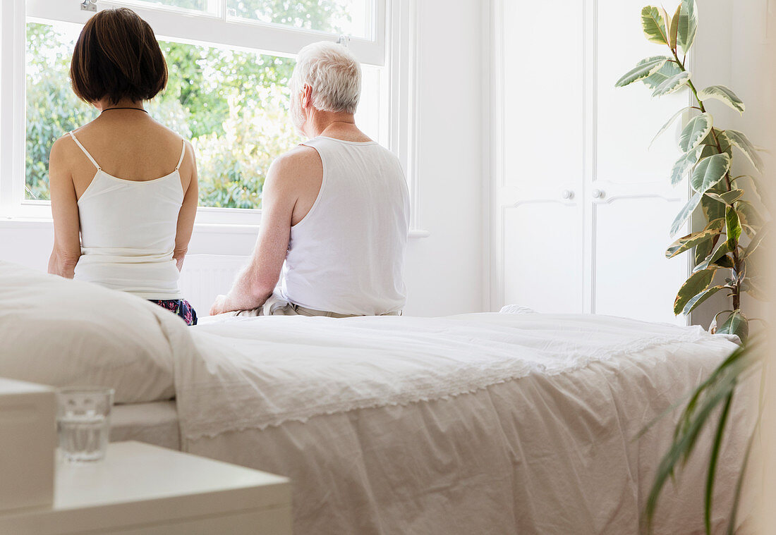 Senior couple sitting on bed