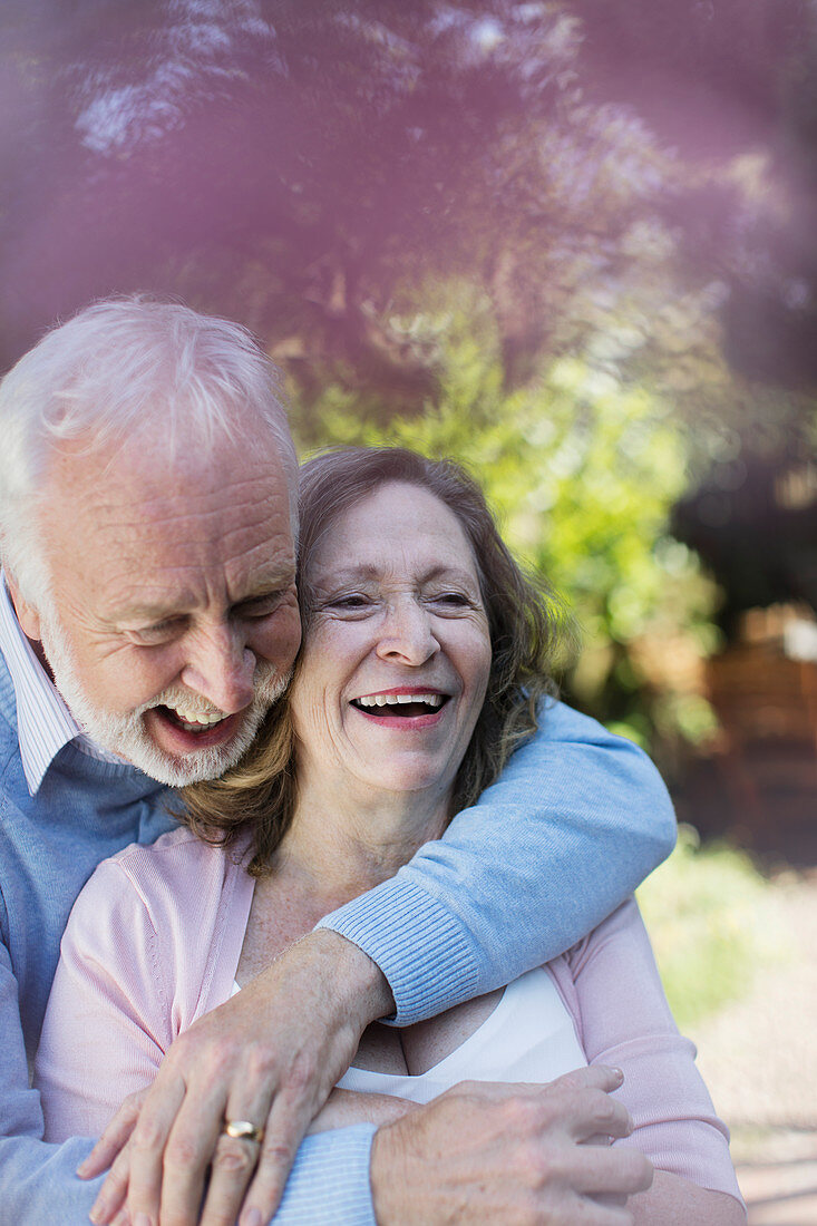 Affectionate, smiling senior couple hugging