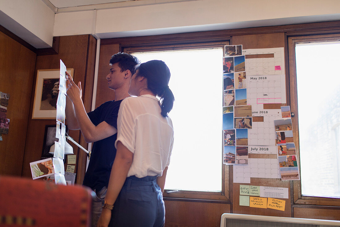 Creative designers reviewing photograph proofs
