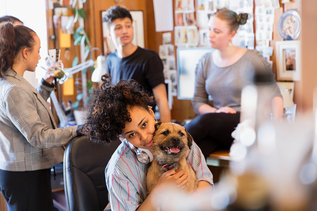 Portrait creative female designer with dog