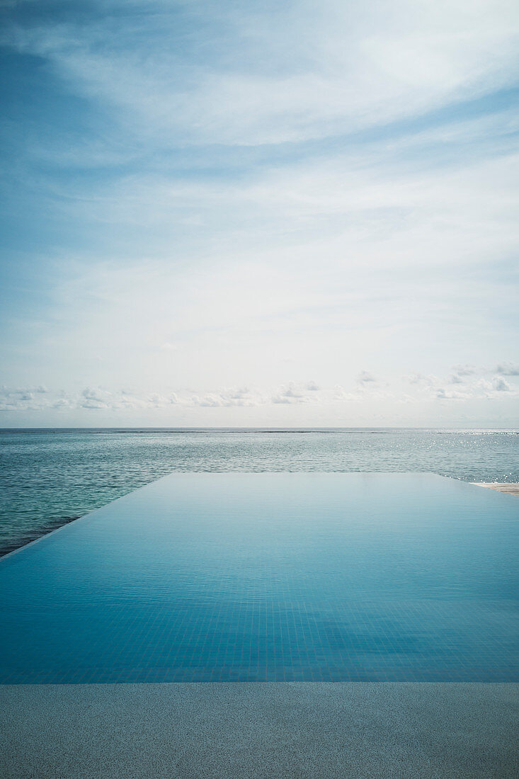 Tranquil blue infinity pool and ocean