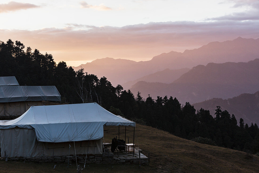 Yurts overlooking silhouetted mountains
