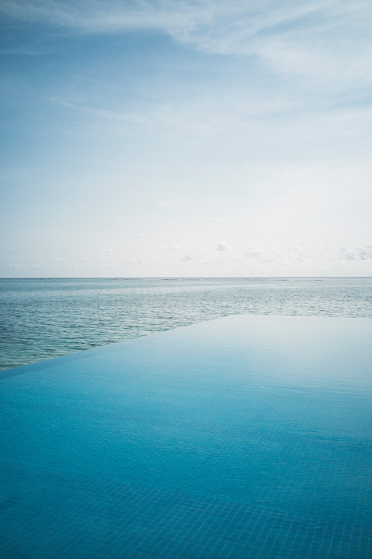 Tranquil blue infinity pool and ocean