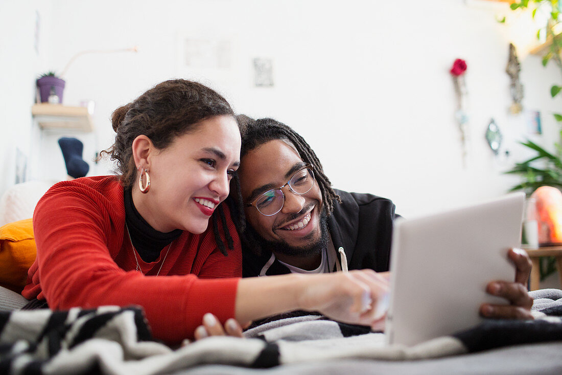 Young couple using digital tablet