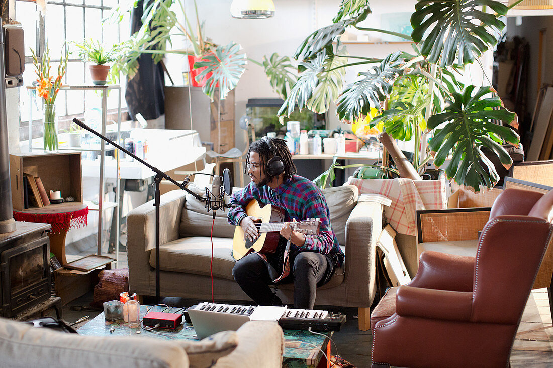 Musician recording music in apartment