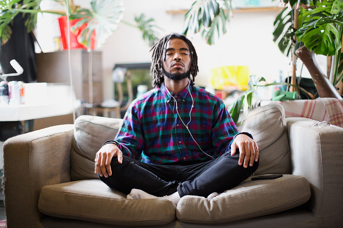 Serene young man meditating