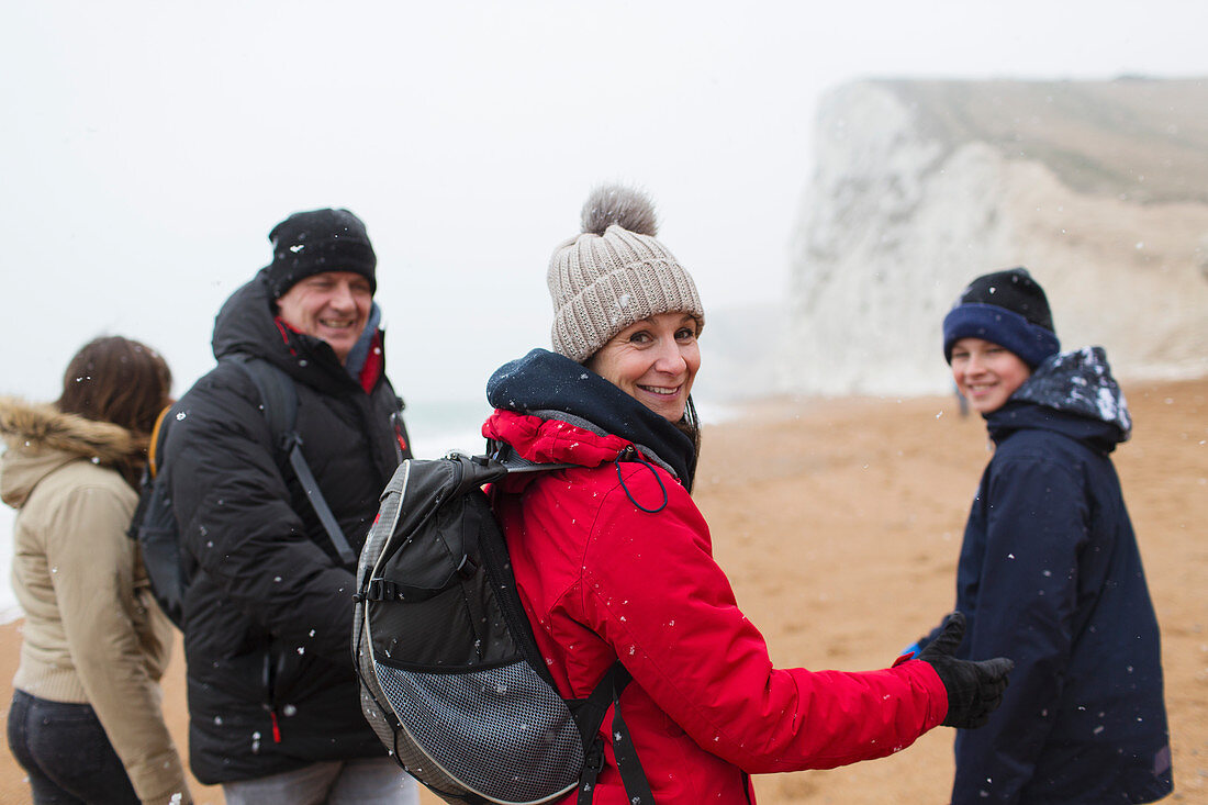 Portrait family on snowy winter beach