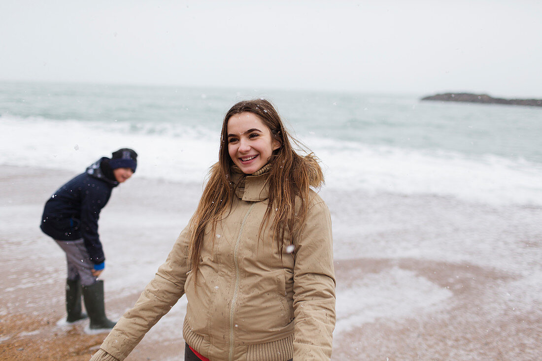 Smiling teenage girl on winter ocean beach