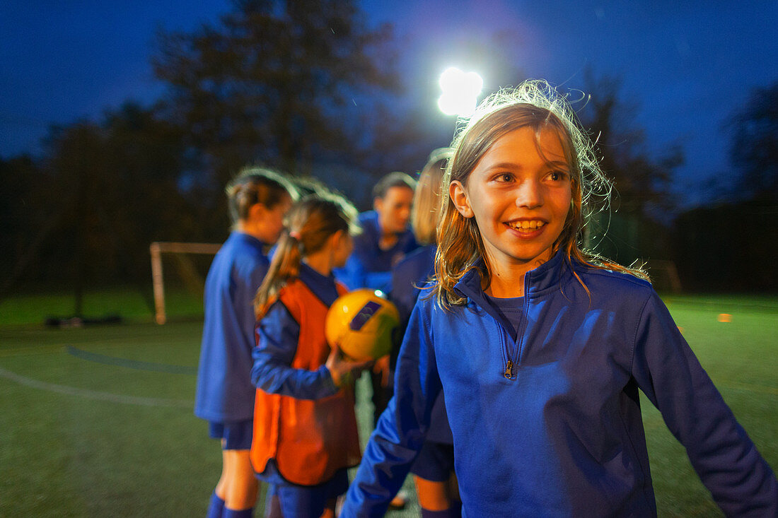 Smiling girl playing soccer