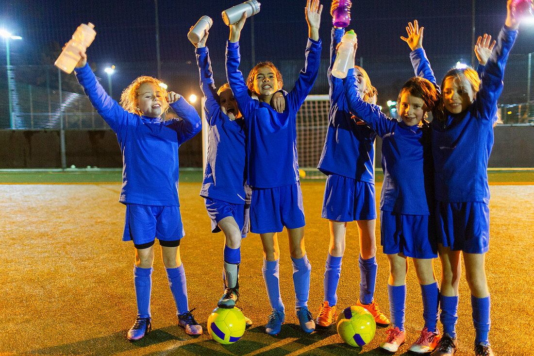Portrait girls soccer team with water bottles