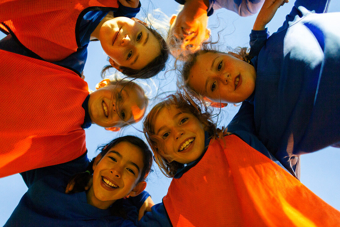 Portrait girls soccer team in huddle