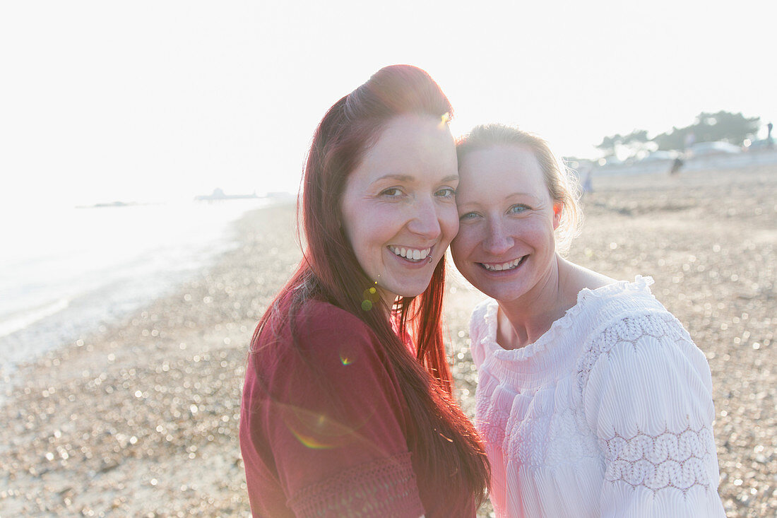 Portrait lesbian couple on beach