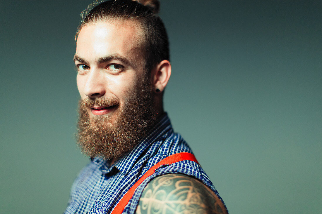 Hipster with beard and shoulder tattoo