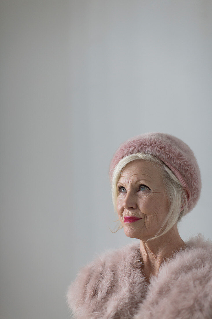 Portrait elegant senior woman wearing pink fur