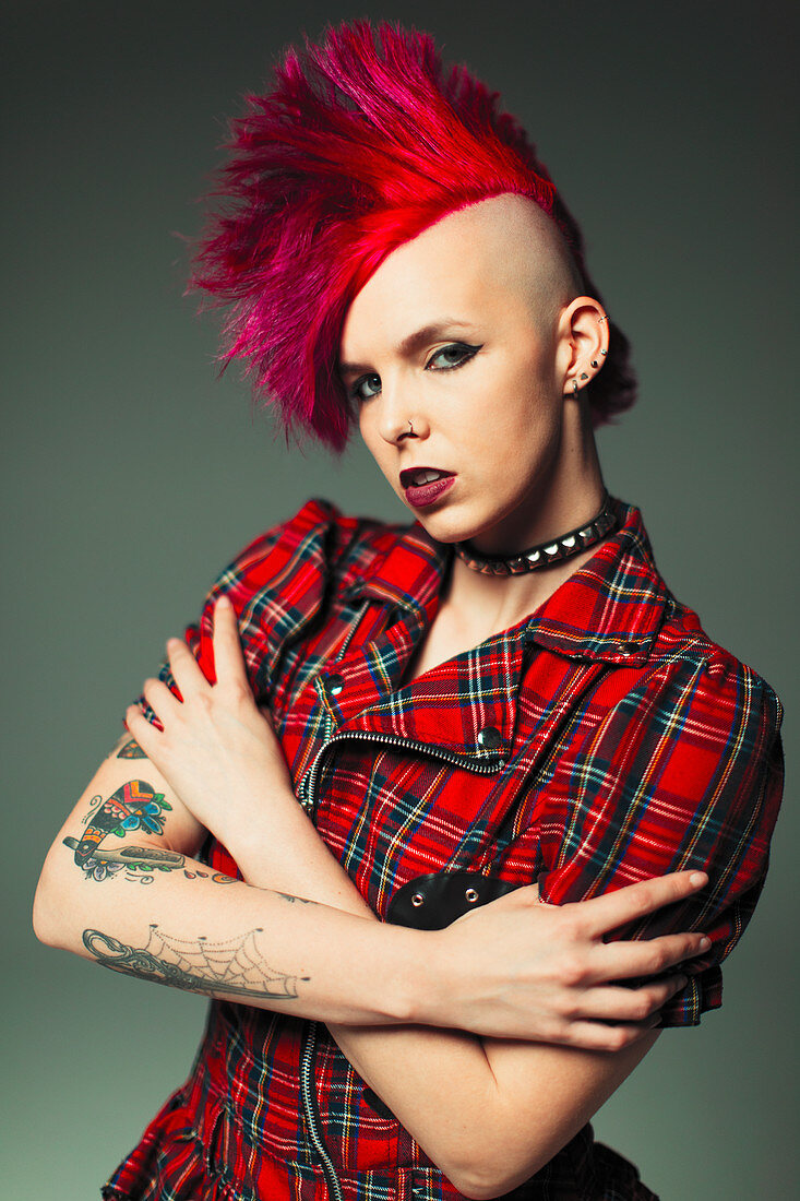 Woman with pink mohawk and tattoos