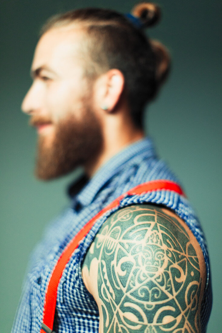 Hipster man with shoulder tattoo and beard