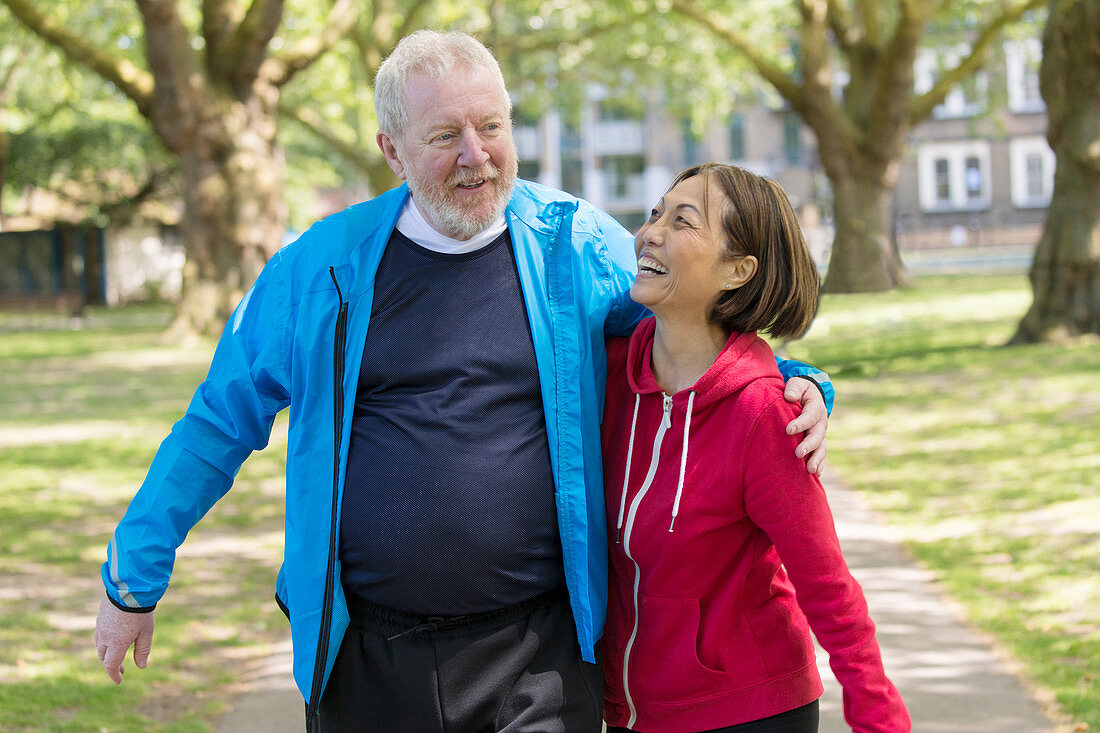 Active senior couple walking in park