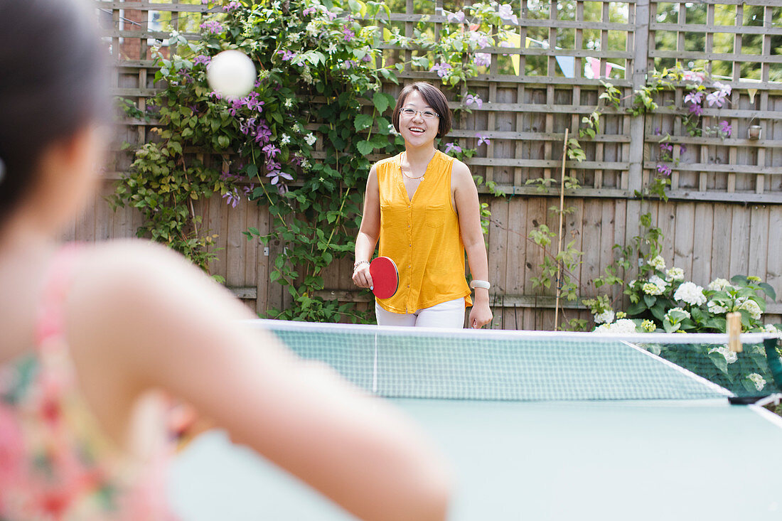 Mother and daughter playing table tennis