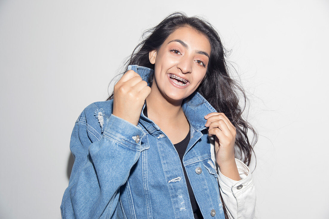Portrait happy, teenage girl wearing denim jacket