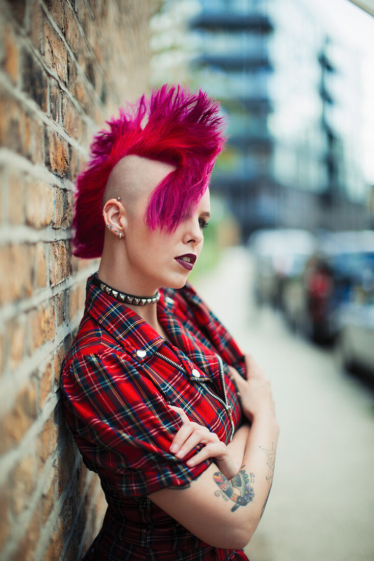 Confident young woman with pink mohawk