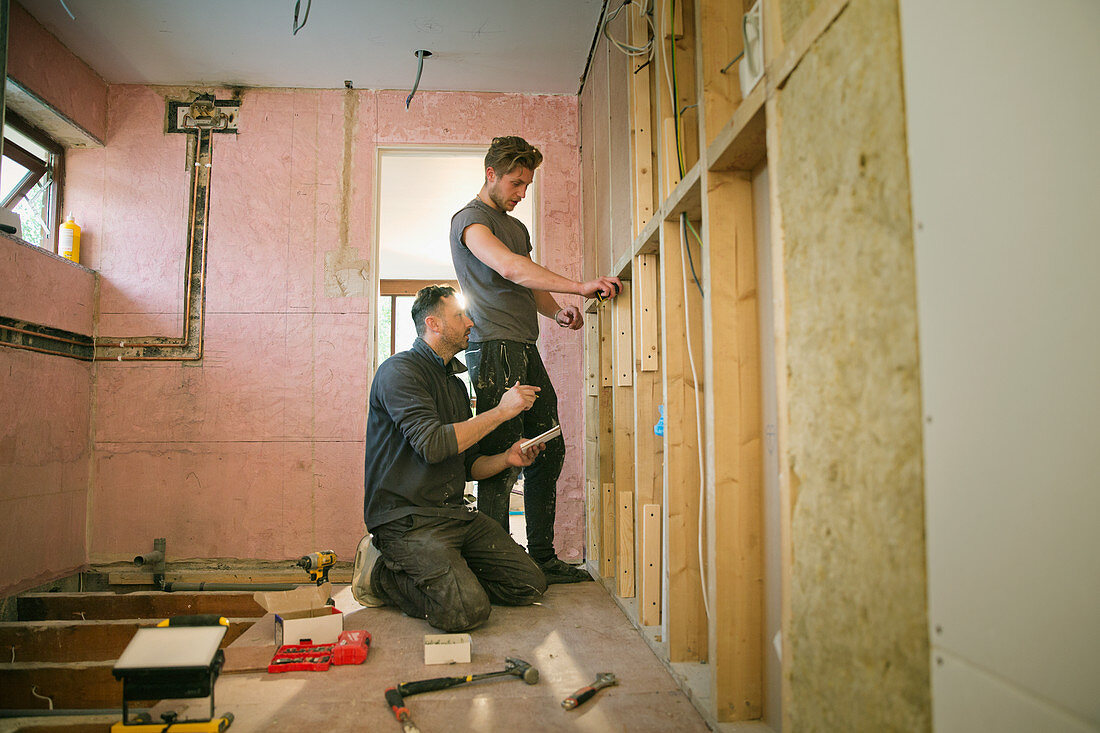 Construction workers framing inside of house