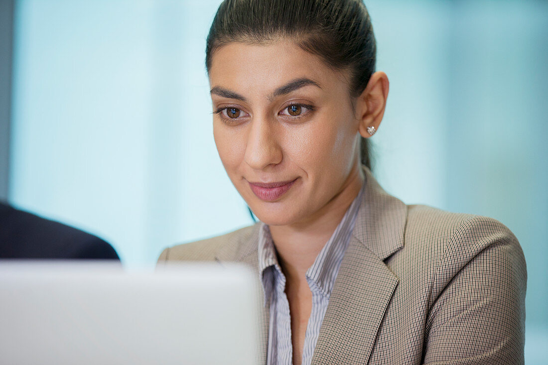 Focused businesswoman using laptop