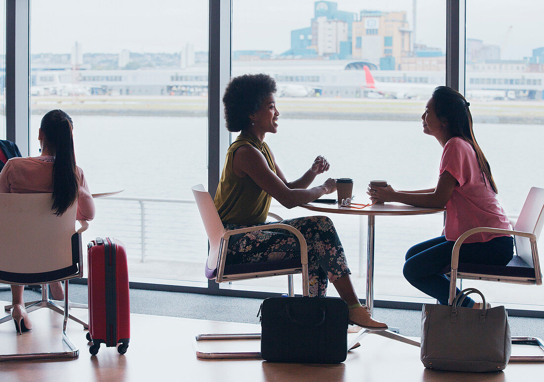 Businesswomen talking in airport business lounge